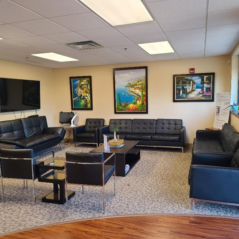 Waiting room at Kentuckiana Pain Specialists, with seating and the reception window
